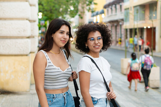 Portrait of two young women on the street.