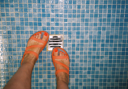 Woman's feet in orange sandals