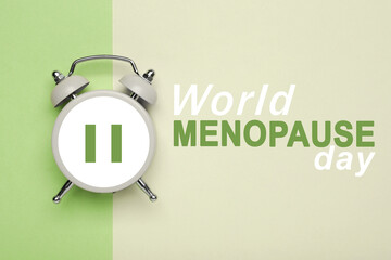 World Menopause Day. Alarm clock with pause symbol on color background, top view