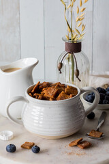 A bowl of homemade low card cinnamon crisp cereal, served with oat milk.