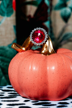 ring with a red gemstone in a pink pumpkin