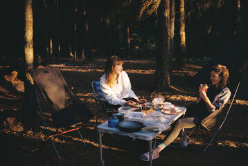 Girl friends relaxing while camping