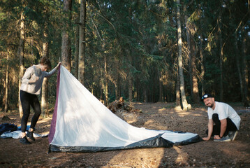 Friends pitching a tent
