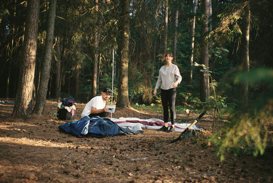 Friends pitching a tent
