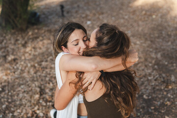 two friends hugging and laughing