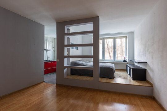 Empty flat ready for rent: open-plan studio with bedroom and kitchen