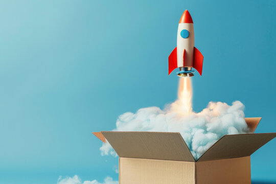Rocket taking off from cardboard box on blue background