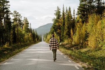 man walk scenic road forest