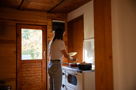 Woman cook breakfast at cabin