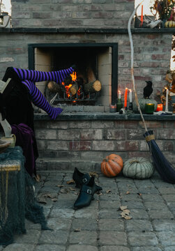 witch's stocking feet on hearth by fire