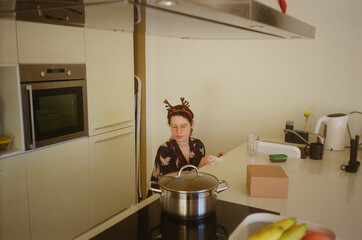 A woman tidying up kitchen during Christmas time