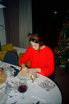 Woman enjoying her entree at Christmas dinner table