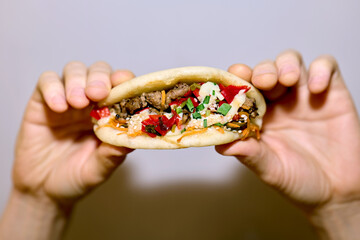Anonymous hands holding meat bao