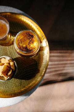 Overhead image of glasses of golden beer on a table