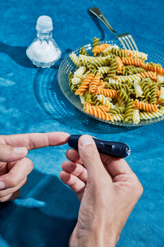 man pricking his finger to measure his sugar level