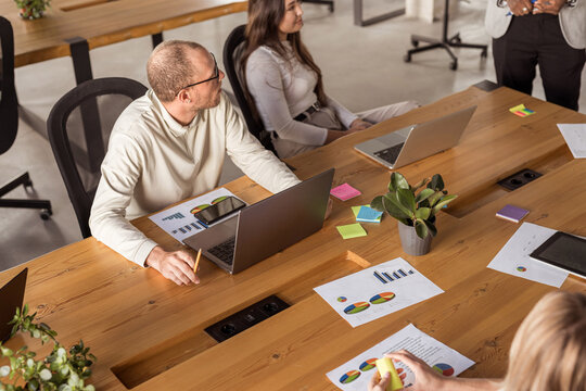 young businessman presents ideas in front of a group of workers