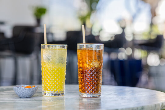 Inviting drinks on a table at an outdoor cafe, with seating and 