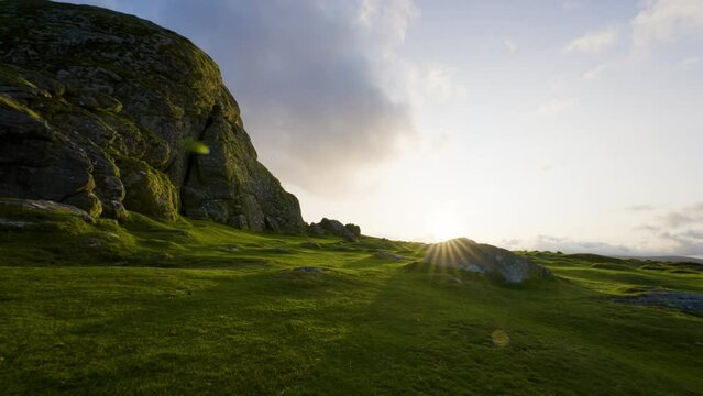 Setting sun over Dartmoor National Park walking over rocky hills