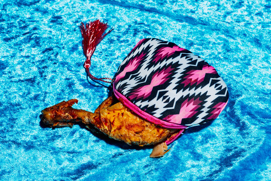 roasted chicken leg popping out of a multicolored purse