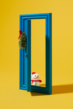 snowman and door with a christmas wreath