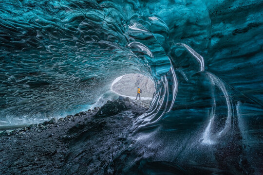 Man exploring an Amazing Glacial Cave in Iceland