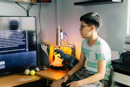 Concentrated teenager playing video games.