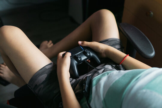 Close-up of a gamer's hands playing on a console.
