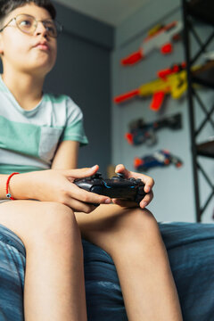 Young man playing video games in his room.