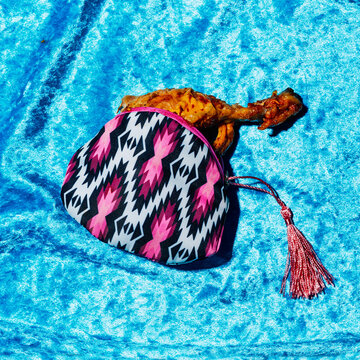 multicolored purse with a roasted chicken leg