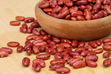 close up of red beans on wooden bowl