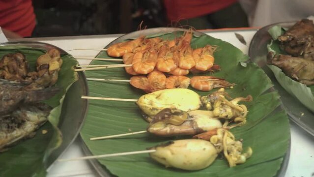 Gourami fish, gizzard liver, skewered squid, skewered shrimp, duck meat, tripe meat, tofu and chicken. Typical Indonesian food with a street food concept. Jakarta Indonesia 11 Maret 2024