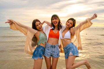 Portrait Group of Asian woman enjoy and fun outdoor lifestyle travel nature ocean on summer beach holiday vacation. Attractive girl friends walking and playing together at the sea on tropical island.