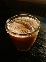 Сup of coffee tea on the black table with a homemade cake decorated with a fresh mint brown sun light morning breakfast drink food baked bakery