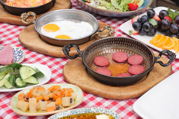 Cooking a dish of breakfast sausage in a pan on a wooden table