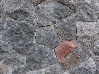 Photo of a natural stone home wall decoration with an isolated red pattern