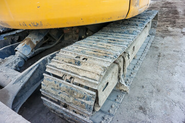 Excavator continuous tracks in construction site, close up