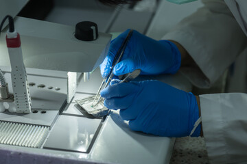 A medical scientist prepares a pathological specimen for a pathologist to diagnose.