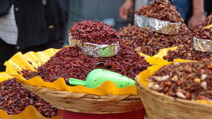 Basket of chili grasshoppers for sale in the market in Oaxaca, Mexico