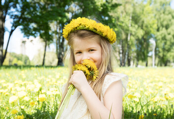 girl in the field smells a dandelion - 759415301