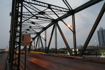 Fototapeta na wymiar bridge with cars light twilight sky