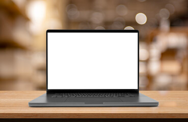 Laptop or notebook with blank screen on wood table in blurry background with house or office modern ,nature orange bokeh and sunlight in morning.