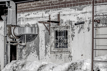 A fragment of the facade of an old industrial building on a winter day