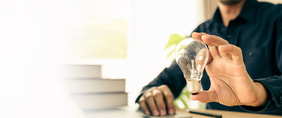 Hand choose light bulb not bright light for creative idea innovation of technology in analyzing global marketing online business plan data management services to target growth concept.