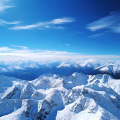 Fototapeta na wymiar A mountain range covered in snow under a clear blue sky