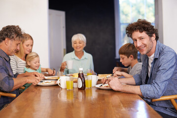 Mature man, family and guest for breakfast at home on happiness in morning for bonding with conversation, support and care. Portrait, meal and eat with coffee in table to enjoy, fun and together.