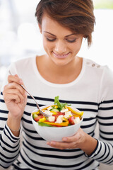 Obraz na płótnie Canvas Happy woman, diet and salad or eating healthy food for detox, breakfast and lunch at home. A young person with green fruits, vegetables and lettuce or vegan meal in bowl for nutrition and wellness