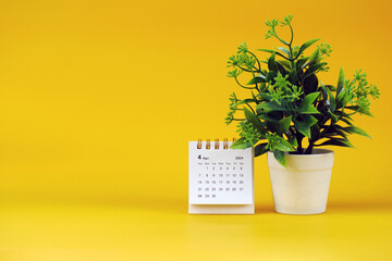 April 2024 month calendar with floral dots on yellow background, copy space