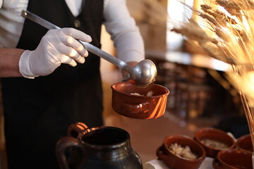 chef serving soup