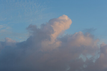 Naklejka na ściany i meble Thick clouds on the blue sky.