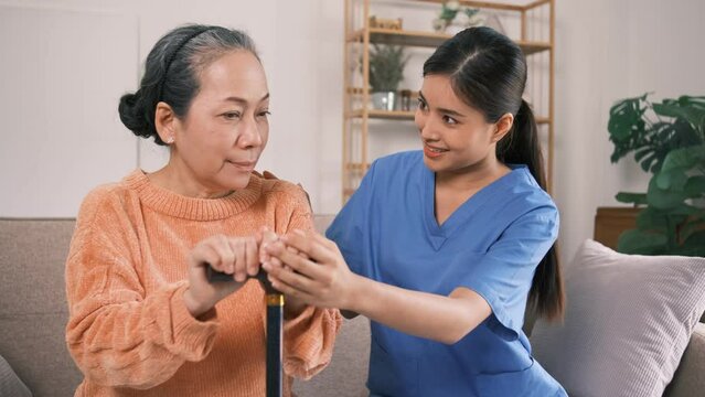 A beautiful Asian private nurse receives an extra job taking care of an elderly woman at a private home to help the elderly woman make things more convenient because the patient is elderly.